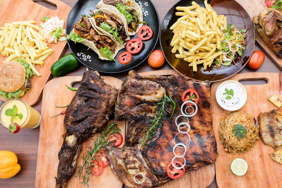 A deliciously grilled Argentine asado with an assortment of meat cuts, accompanied by chimichurri sauce and roasted vegetables.